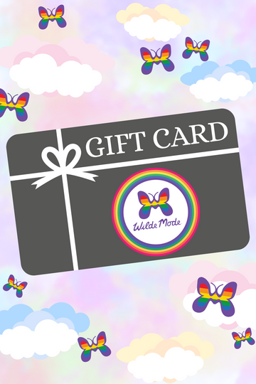 illustration of WildeMode gift card with WildeMode butterfly logo on the front and a white ribbon. The background of the photo is a pastel rainbow sky with white clouds and WildeMode rainbow butterflies.