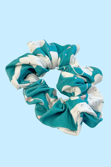 Happy Little Clouds cute blue hair scrunchie with smiley clouds print. Sustainably made from fabric off-cuts from Wilde Mode Active and Loungewear collections