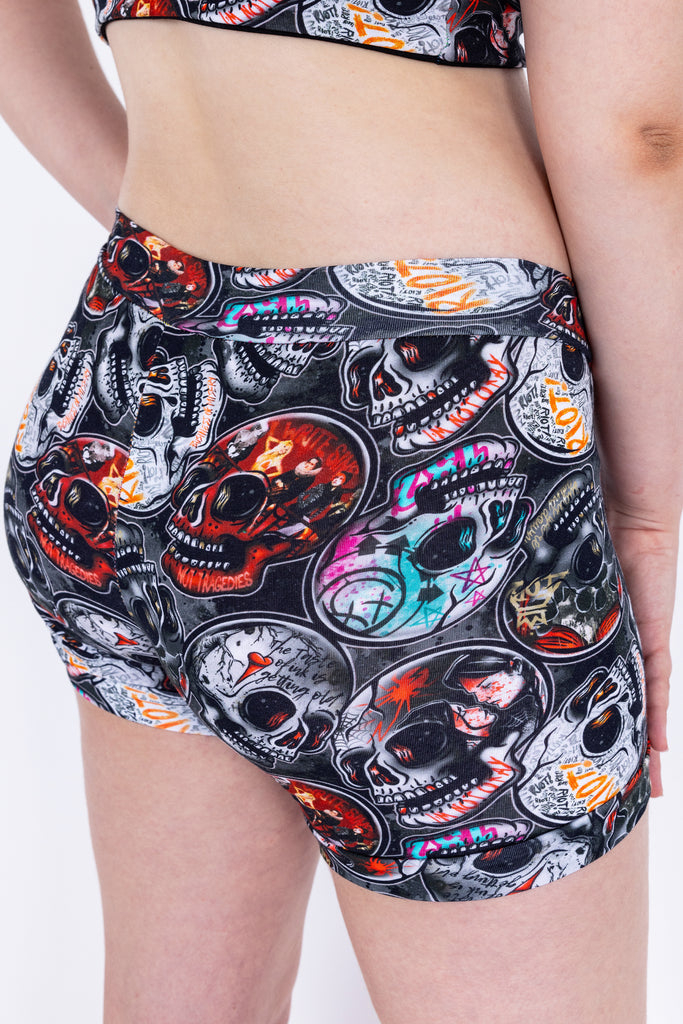 Close up of Emo Skulls active loungewear boxers shorts pants are black grey with red blue orange emo alternative music bands print. Made sustainably in the UK by Wilde Mode.