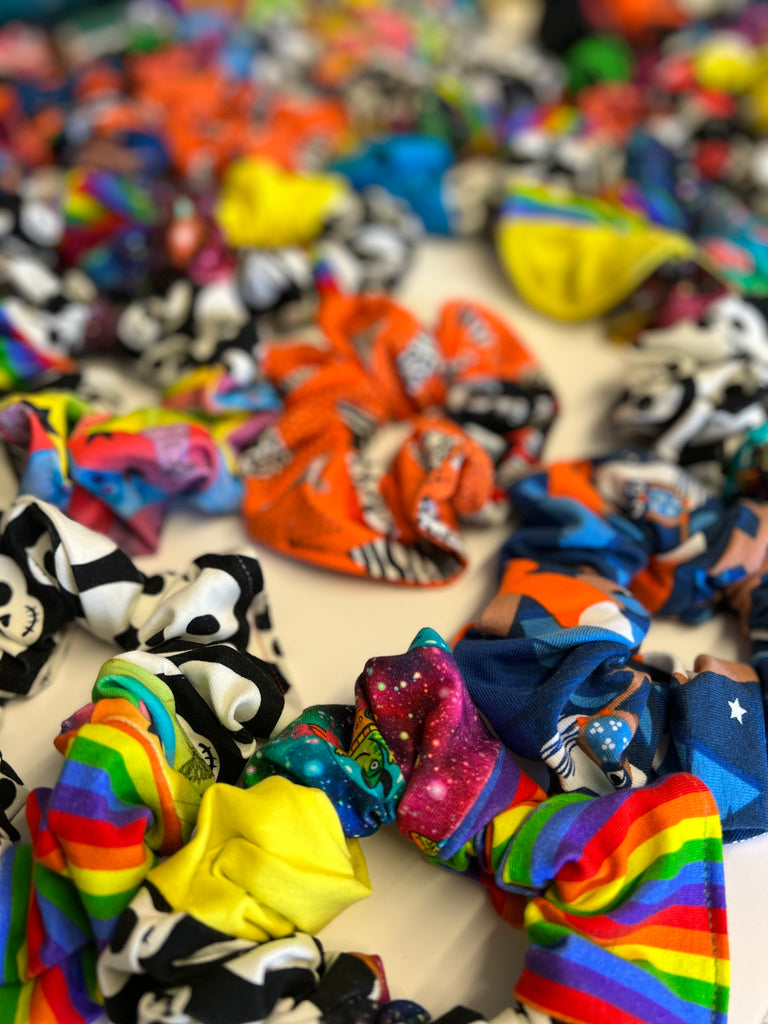 a handful of sustainable patchwork hair scrunchies. Each one is unique and made from various Wilde Mode fabric scraps